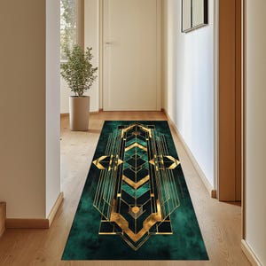 May include: A green and gold geometric patterned runner rug with a modern art deco design. The rug has a dark green background with gold lines and shapes.