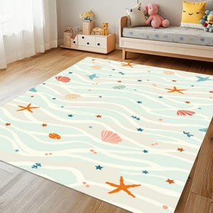 May include: A light blue and white rug with a wavy pattern. The rug features a variety of sea-themed illustrations, including seashells, starfish, and small blue stars.