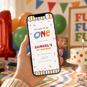 May include: A smartphone displays a colorful birthday invitation with the text "It's Fun to Be One" and "Samuel's 1st Birthday." The design includes stars, swirls, and a striped border. A cake with a lit candle and balloons are in the background.