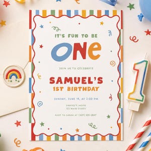 May include: A colorful birthday invitation with the text "IT'S FUN TO BE ONE" and "SAMUEL'S 1ST BIRTHDAY". The invitation has a red, blue, orange, and yellow border. A number one candle and confetti are also present.
