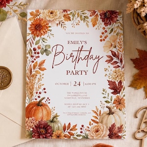 May include: A rectangular birthday party invitation card featuring a white background with a border of watercolour autumn leaves, berries, and flowers. The text reads: YOU'RE INVITED TO EMILY'S Birthday PARTY OCTOBER 24 6:00 PM THE MAPLE HOUSE 214 HARVEST LANE NASHVILLE, TENNESSEE KINDLY RSVP BY OCT 3 AT 123 456 7890 An evening of dinner, cocktails, and unforgettable memories. Two pumpkins are at the bottom.