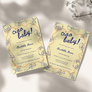 May include: A yellow baby shower invitation with a blue and orange design. The invitation says "Ciao Baby!" and includes the details for Charlotte Davis's baby shower.