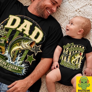 May include: Black matching t-shirts and baby bodysuit with fishing-themed graphics. The adult shirt says "DAD" with a fish illustration. The baby bodysuit says "DAD'S FISHING BUDDY" with a fish graphic.