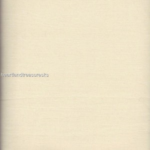 May include: A close-up of a cream-colored fabric with a subtle woven texture. A ruler is visible at the bottom of the image, showing measurements in inches.