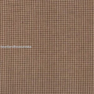 May include: Brown and beige gingham fabric with a subtle texture. The fabric is measured with a ruler in inches.