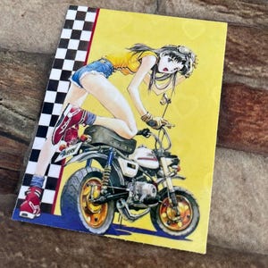 May include: A yellow and black checkered border surrounds a yellow background with a cartoon illustration of a woman wearing a yellow tank top, blue denim shorts, and red shoes riding a small white motorcycle.