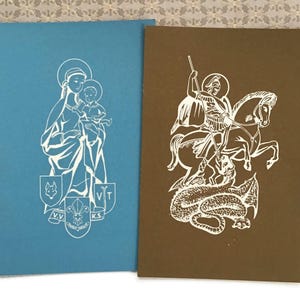 May include: A set of three ceramic mugs with a speckled, matte finish. The mugs are in shades of cream, light gray, and dark gray. Each mug has a simple, minimalist design and a rounded handle.