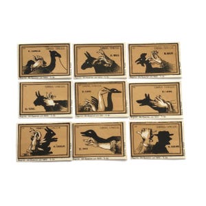 Etiquetas para cajas de cerillas estilo vintage – Juego de 9 diseños de marionetas de sombras – Serie reimpresa en español (aprox. década de 1960)
