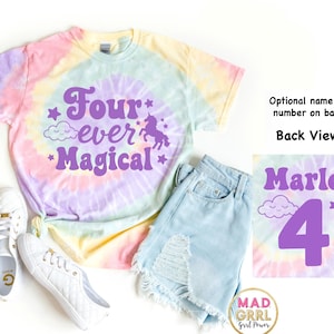 May include: A tie-dye t-shirt with the words "Four ever Magical" in purple, along with a unicorn and stars. The shirt is paired with light blue denim shorts and white sneakers. The back view shows the name "Marley" and the number "4".