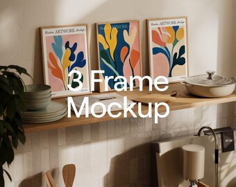 May include: Three framed art prints with colourful abstract floral designs. The frames are light brown, and the artwork features blue, orange, yellow, and pink shapes. The text "Custom ARTWORK Mockups" is visible on the frames. The text "3 Frame Mockup" is in the centre.