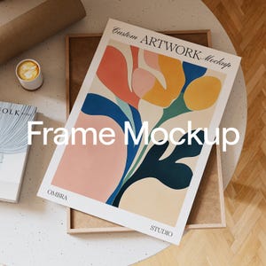 May include: A framed print with an abstract floral design in shades of pink, yellow, blue, and green. The frame is made of wood and has a natural finish. The print is titled "Custom Artwork Mockup" and "Frame Mockup" and includes the text "OMBRA STUDIO".