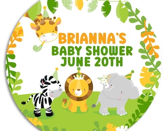 May include: A round, white sticker with a green, yellow, and orange jungle theme. It features a zebra, lion, and giraffe wearing party hats. The text reads "Brianna's Baby Shower June 20th".