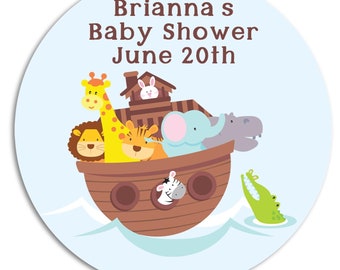 May include: A blue and white round sticker with a brown ark filled with animal figures, including a giraffe, lion, elephant, and hippopotamus. The text on the sticker reads "Brianna's Baby Shower June 20th".