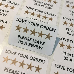 May include: White stickers with gold stars and the text "Love your order? Please leave us a review."