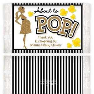 May include: A black and white striped background with a white label. The label has a gold glitter silhouette of a pregnant woman, popcorn, and the text "About to POP! Thank You for Popping By Brianna's Baby Shower".