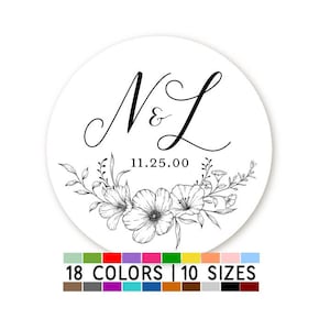 May include: A white round sticker with black floral designs and the initials "N & L" with the date "11.25.00" in the center. The sticker is available in 18 colors and 10 sizes.