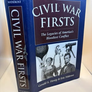 May include: A hardcover book titled "Civil War Firsts" with a dark blue cover. The book features the text "Civil War Firsts" in large white letters. The cover also includes illustrations and the authors' names.