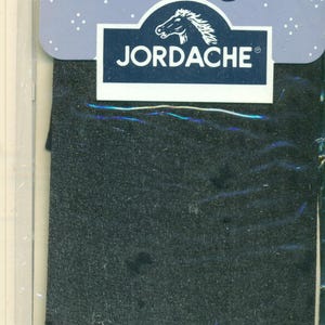 May include: A close-up of a dark gray fabric with the brand name "Jordache" in white letters on a navy blue background. The Jordache logo features a white horse head. The fabric has a textured appearance.