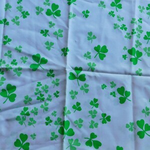 May include: White pillowcase with a green shamrock pattern. The pillowcase has a scalloped edge and is decorated with various sizes of green shamrocks, perfect for St. Patrick's Day or Irish-themed decor.