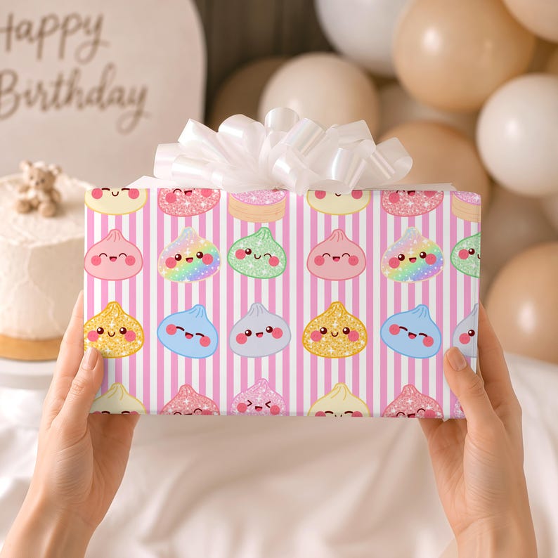 May include: A rectangular gift box wrapped in pink and white vertical striped paper featuring a repeating pattern of smiling, colorful dumpling characters with glittery textures, topped with a large, white, multi-looped decorative ribbon bow.