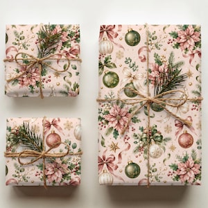 May include: Three rectangular gift boxes wrapped in light pink paper featuring a repeating pattern of green ornaments, pink poinsettias, gold stars, and ribbons. Each package is tied with brown twine and decorated with a small sprig of pine needles.