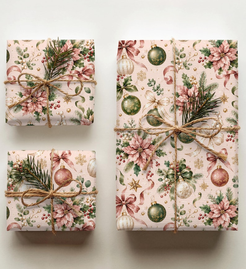May include: Three rectangular gift boxes wrapped in light pink paper featuring a repeating pattern of green ornaments, pink poinsettias, gold stars, and ribbons. Each package is tied with brown twine and decorated with a small sprig of pine needles.