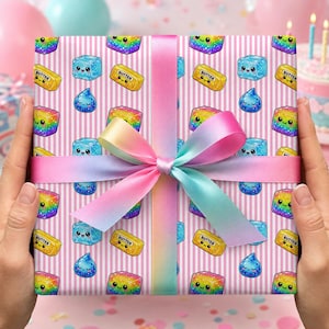 May include: A square gift box wrapped in pink and white striped paper featuring a repeating pattern of cute, smiling cartoon butter sticks, blue ice cubes, and water droplets, tied with a wide, smooth, gradient rainbow-colored satin ribbon.