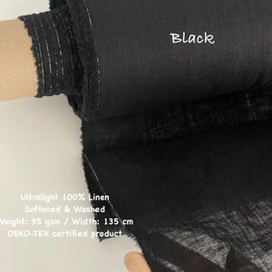 May include: A roll of black ultralight 100% linen fabric. The fabric is softened and washed, with a weight of 95 gsm and a width of 53 inches. The text "Black" is visible on the fabric. The product is OEKO-TEX certified.
