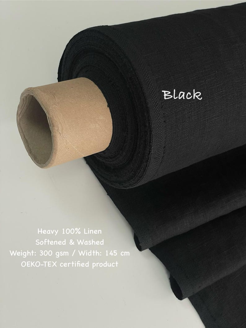 May include: A roll of black linen fabric. The text "Black" is written on the fabric. The fabric is labeled as heavy 100% linen, softened and washed, with a weight of 300 gsm and a width of 145 cm. It is an OEKO-TEX certified product.