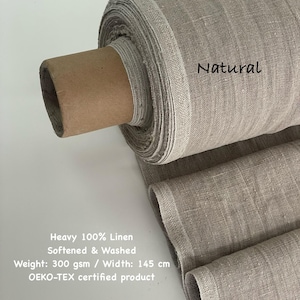 May include: A roll of natural-colored, heavy 100% linen fabric. The fabric is softened and washed, with a width of 57 inches. The text "Natural" is visible on the fabric. The product is OEKO-TEX certified.