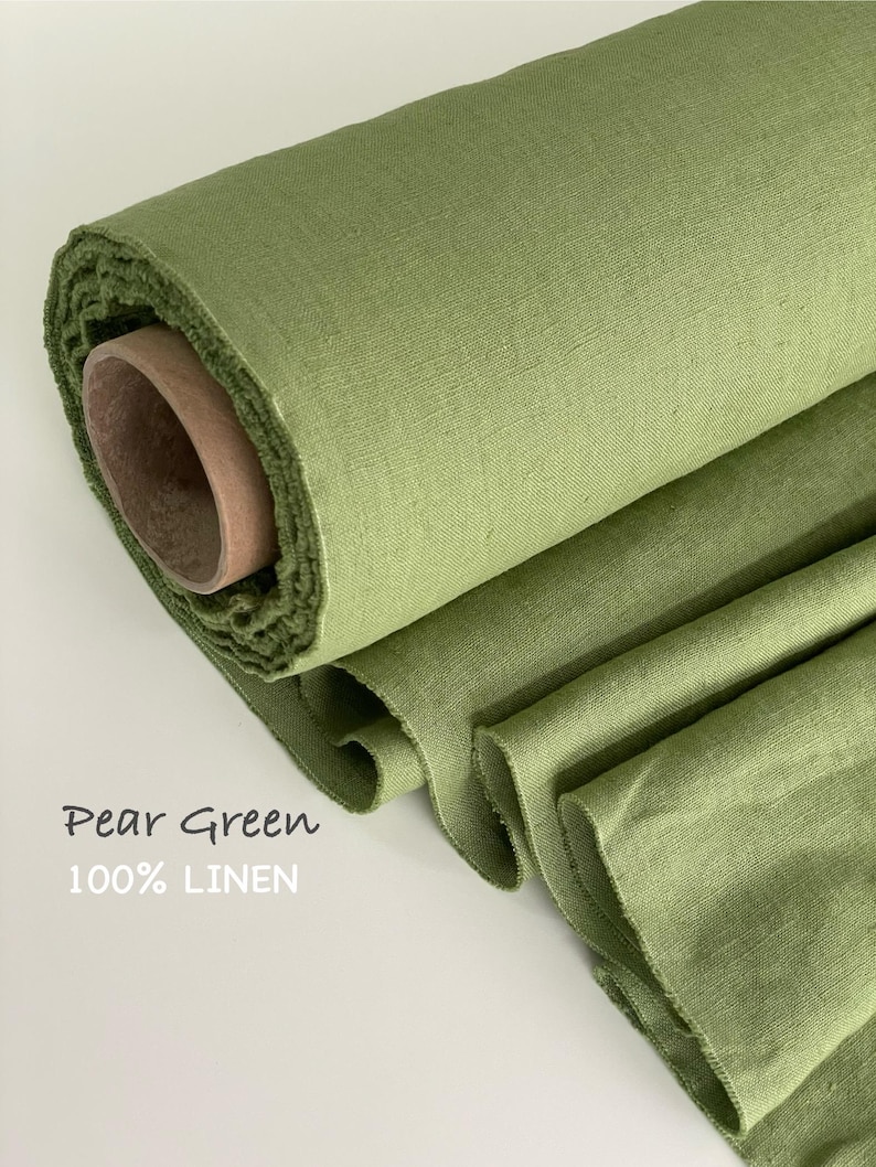 May include: A roll of pear green 100% linen fabric with a visible woven texture. The fabric is wrapped around a cylindrical cardboard core, with several layers of the green textile cascading downward. The text Pear Green 100% LINEN is visible.