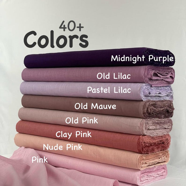 May include: A stack of eight fabric bolts in various shades of purple and pink, labeled 40+ Colors. The colors include Midnight Purple, Old Lilac, Pastel Lilac, Old Mauve, Old Pink, Clay Pink, Nude Pink, and Pink, with a draped fabric piece below.