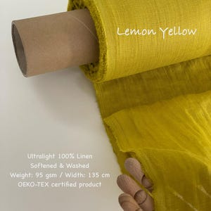 May include: A roll of lemon yellow ultralight 100% linen fabric. The fabric is softened and washed, with a width of 53 inches. The text "Lemon Yellow" is written on the fabric. The fabric is an OEKO-TEX certified product.