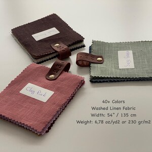 May include: Three stacks of square linen fabric swatches in clay pink, dark brown, and sage green. Each stack is secured with a brown leather tab and a gold metal rivet. Text reads: 40+ Colors, Washed Linen Fabric, Width: 54" / 135 cm, Weight: 6.78 oz/yd2 or 230 gr/m2.