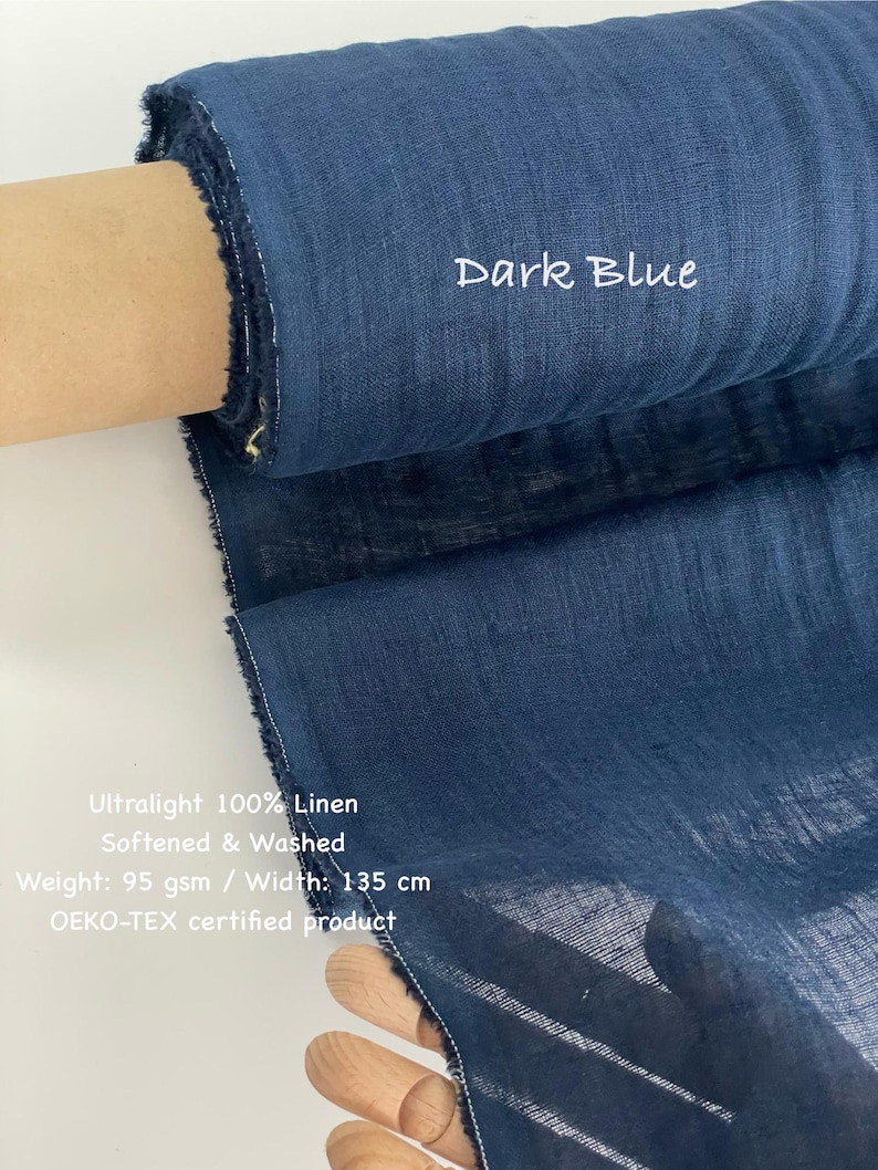 May include: A roll of dark blue ultralight 100% linen fabric. The fabric is softened and washed, with a width of 135 cm. The text "Dark Blue" is visible on the fabric. The fabric is an OEKO-TEX certified product.