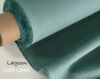 May include: A roll of lagoon-colored 100% linen fabric. The textile features a visible woven texture and a soft, matte finish. The fabric is wrapped around a cardboard core, displaying a consistent teal-green hue throughout the material.