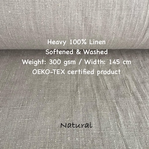 May include: A roll of natural-colored, heavy 100% linen fabric. The fabric is softened and washed, with a weight of 300 gsm and a width of 145 cm. The text "Natural" is written on the fabric. The product is OEKO-TEX certified.