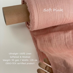 May include: A roll of soft pink ultralight 100% linen fabric. The fabric is softened and washed, with a weight of 95 gsm and a width of 135 cm. The text "Soft Pink" is visible on the fabric. The product is OEKO-TEX certified.