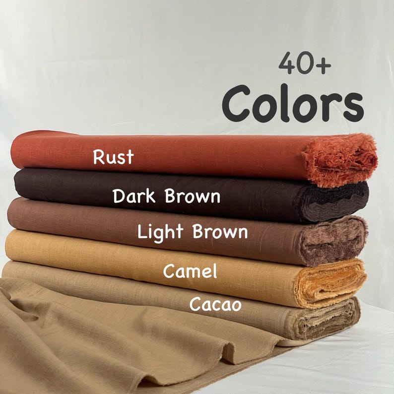 May include: A stack of five fabric rolls in various earth tones, including rust, dark brown, light brown, camel, and cacao. The text 40+ Colors is displayed above the rolls, with individual color names printed on each corresponding fabric layer.