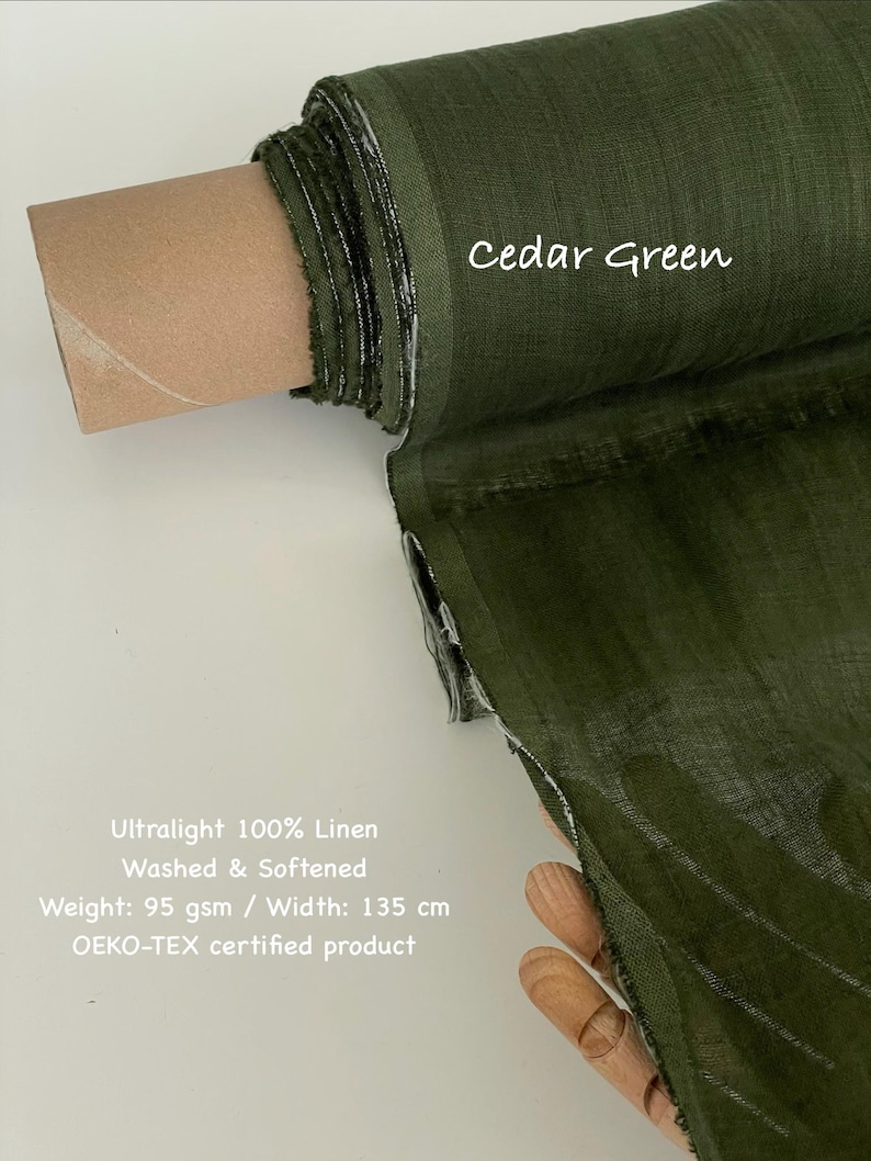 May include: A roll of cedar green ultralight 100% linen fabric. The fabric is washed and softened, with a weight of 95 gsm and a width of 135 cm. The text "Cedar Green" is written on the fabric.