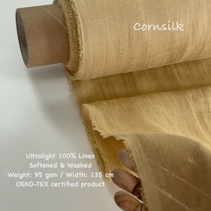 May include: A roll of cornsilk-colored, ultralight 100% linen fabric. The fabric is softened and washed, with a weight of 95 gsm and a width of 135 cm. The text "Cornsilk" is visible on the fabric. The product is OEKO-TEX certified.