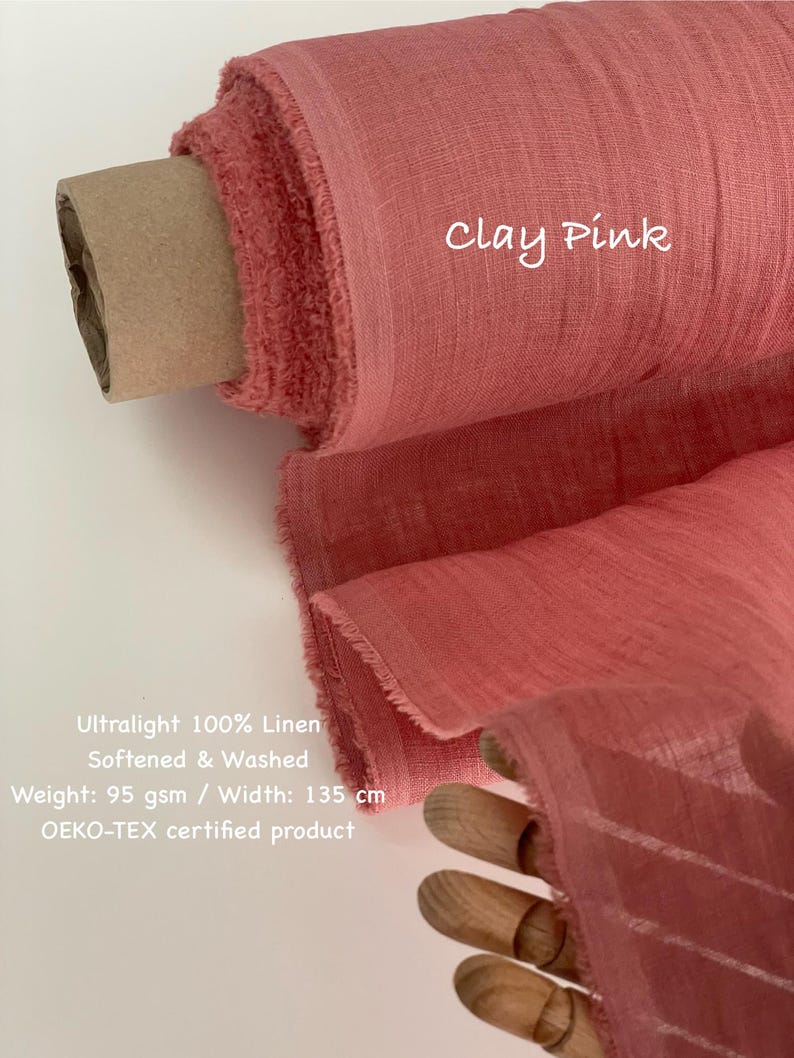 May include: A roll of clay pink 100% linen fabric. The fabric is ultralight, softened, and washed. The width is 135 cm. The text "Clay Pink" is written on the fabric. The fabric is OEKO-TEX certified.
