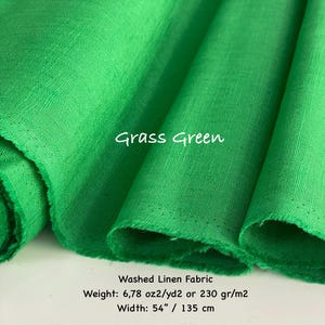 K&ouml;nnte beinhalten: Grasgr&uuml;ner gewaschener Leinenstoff mit sichtbarer Webstruktur. Der Text auf dem Stoff lautet Grass Green. Zus&auml;tzlicher Text gibt an: Washed Linen Fabric, Gewicht: 230 gr/m2 und Breite: 135 cm.