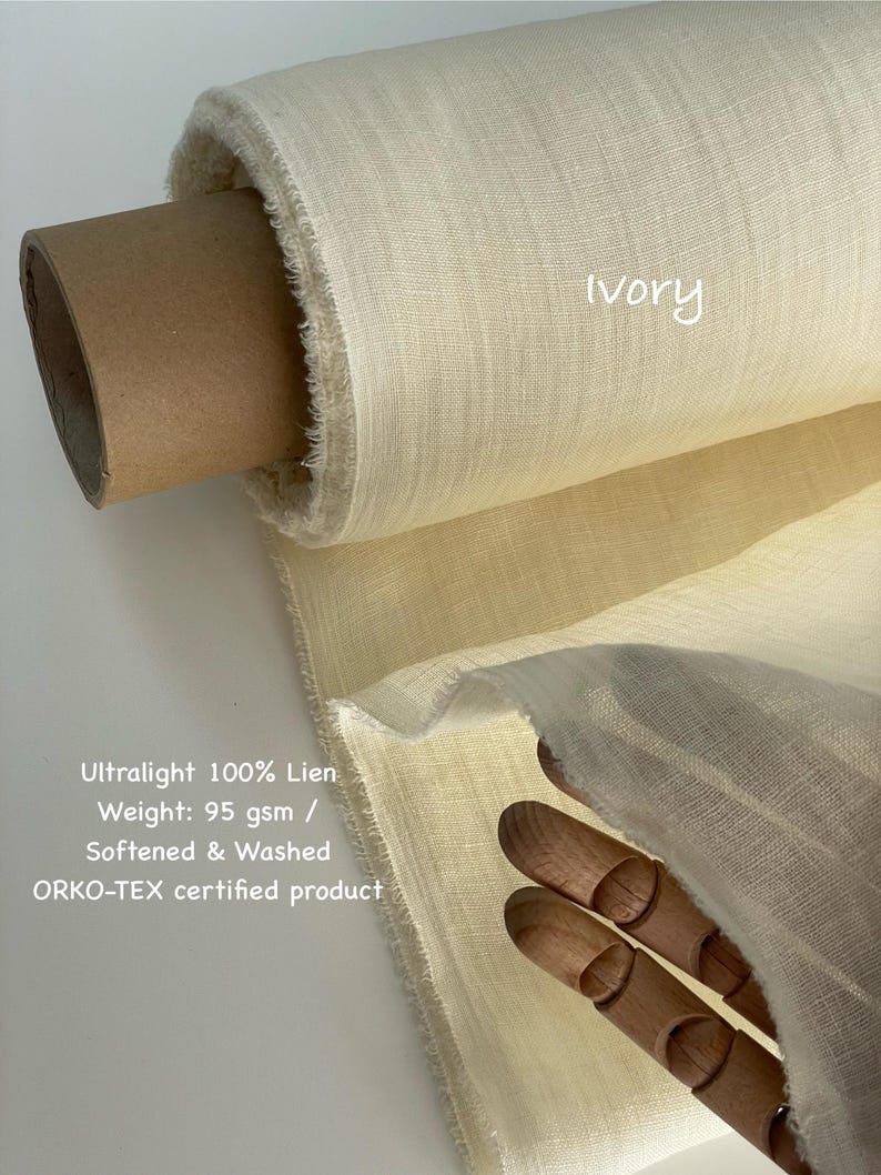 May include: A roll of ivory-colored, ultralight 100% linen fabric. The fabric is labeled as 95 gsm, softened, washed, and ORKO-TEX certified. The word "Ivory" is written on the fabric.