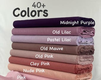 May include: A stack of fabric rolls in various shades of pink, purple, and mauve. The image displays a range of colors, including "Midnight Purple," "Old Lilac," and "Pink." The text "40+ Colors" is at the top.