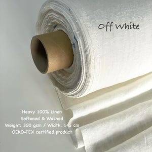 May include: Off-white linen fabric roll. The fabric is labeled "Off White" and is described as heavy 100% linen, softened, and washed. The width is 145 cm. The product is OEKO-TEX certified.