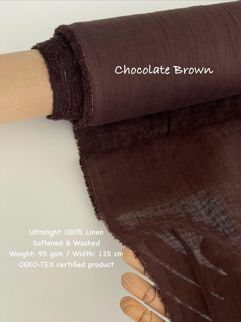 May include: A roll of ultralight, chocolate brown 100% linen fabric. The fabric is softened and washed, with a weight of 95 gsm and a width of 135 cm. The text "Chocolate Brown" is visible on the fabric.