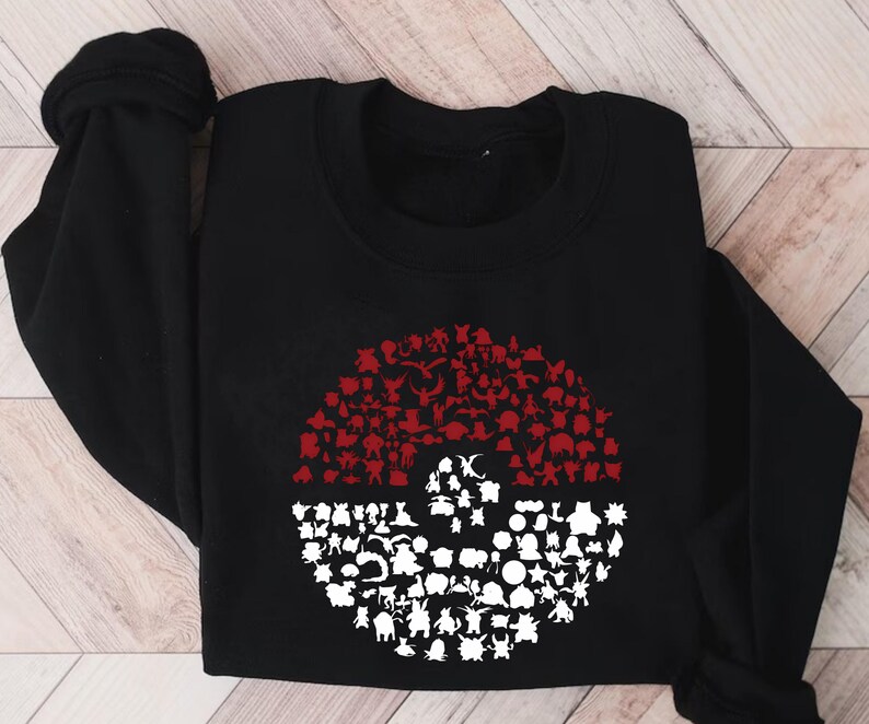 May include: Black sweatshirt with a red and white Pokeball design. The Pokeball is made up of many different Pokemon characters.