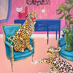 May include: Two leopard print ceramic figurines sit in a pink room with a blue dresser and a chandelier. One leopard is sitting in a teal armchair with a green pillow. The other leopard is on the floor with popcorn scattered around it.