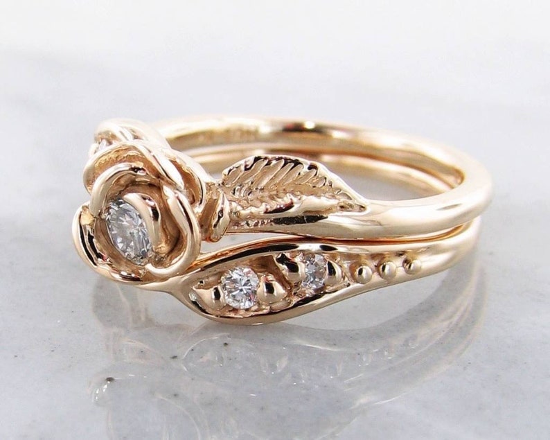 Side view of yellow gold rose and leaf wedding ring set with diamonds